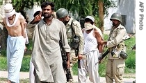 Pakistani army soldiers escort detained blindfolded hardcore militants who were holed up in The Red Mosque, 05 Jul 2007