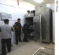 The bodies of two Palestinians are seen in the morgue of the al-Aqsa hospital, in the central Gaza Strip, 05 July 2007