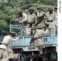 Pakistani paramilitary soldiers get down from a truck beside the radical Red Mosque in Islamabad, 06 July 2007