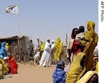 A picture taken by the WFP in February 2007 shows displaced Sudanese people at the WFP food aid distribution center of the Otash IDP camp in Nyala, Sudan