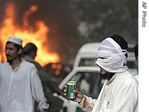 A religious student takes a drink during a clash outside the Lal mosque in Islamabad, Pakistan, 04 July 2007