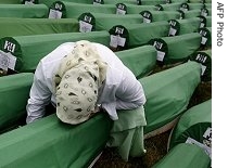 A Bosnian Muslim woman cries over a coffin with the remains of her relative in Potocari, near Srebrenica, during the funeral ceremony of 465 Bosnian Muslims, 11 Jul 2007