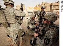 US soldiers prepare to search homes in the Dora neighborhood of Baghdad, Iraq Thursday, June 28, 2007