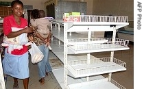 Zimbabwean shoppers walk past empty shelves in Mabvuku,Harare 04 Jul 2007