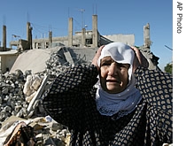 Lebanese woman reacts after looking at rubble of one of three destroyed houses hit by two Israeli air strikes Sunday in the village of Brital, Monday, August 14, 2006