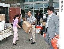 Adel Tolba, right, head of the International Atomic Energy Agency's (IAEA) inspection team, loads equipment onto a truck upon arrival in North Korea