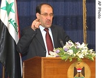 Iraq's Prime Minister Nouri Al-Maliki gestures as he speaks during a press conference in Baghdad, 14 July 2007