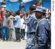 Ethiopian policemen look at students demonstrating at Addis Ababa university, Ethiopia, 06 June 2005