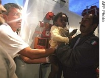 An illegal immigrant baby receives first aid in Lampedusa harbour late as part of a group of 26 illegal immigrants from Eritrea intercepted by the Guardia di Finanza (border police) 30 miles off the coast of Lampedusa island, 29 June 2007