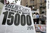 Indian newspaper vendors sell newspaper which says 'Sensex Hits 15000' near a train station in Mumbai, 6 July 2007