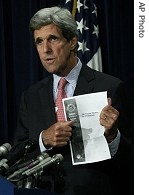 Sen. John Kerry hold up a copy of a National Intelligence Estimate report entitled: 