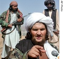 Abdullah Mehsud, a former Guantanamo Bay prisoner, talks to the media as his bodyguard stand guard near Chagmalai in South Waziristan along the Afghan border (2004 file photo)