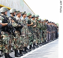 Thai soldiers and police officers stand as pay their respects to a colleague who was shot dead by militants during a funeral ceremony at the airport in Narathiwat province, 03 Aug 2007