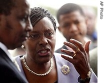 Charity Ngilu, surrounded by plain clothes officers, shows her anger as she is detained at the Kenyan Criminal Investigations Department Headquarters in Nairobi, 3 Aug 2007
