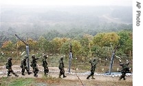 South Korean Army soldiers patrol along barbed-wire fence in Paju, north of Seoul, near demilitarized zone (file photo)
