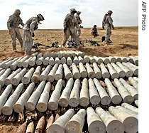A picture released by Department of Defense shows US soldiers lining up mortar shells, anti-tank, anti-personnel, and anti-aircraft rounds found in a weapons cache in western Iraq (File Photo - 27 Feb 2006)