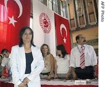 Independent candidate Aysel Tugluk  stands before completing registration formalities at the Turkish parliament in Ankara, 29 Jul 2007