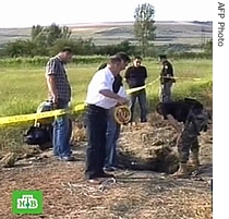Russian NTV channel Television grab shows Georgian investigators looking at the hole allegedly left by a rocket fired from a Russian warplane in Gori, South Ossetia, 07 Aug 2007
