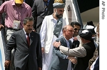 Ali Mohammad Jan Orakzai head of the Pakistani representative, right second, greets with Afghan officials at the Kabul international airport in Kabul, Afghanistan, on Wednesday, 8 Aug. 2007