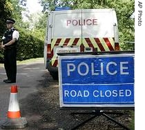 Police close off a road to Hunts Hill Farm where a precautionary culling of animals is to take place in Normandy, 08 Aug 2007