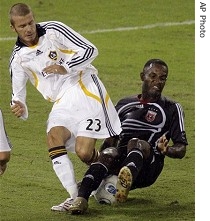 Los Angeles Galaxy's midfielder David Beckham, left, from England, fights for control of the ball against DC United Luciano Emilio