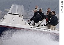 U.S. President Bush (2nd L) waves with his brother Jeb Bush (2nd R) as they fish off the coast of Kennebunkport, Maine with their father, former President George H. W. Bush (L), 10 Aug 2007