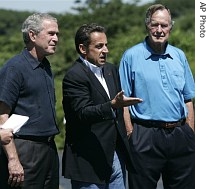President Bush, left, stands with French President Nicolas Sarkozy at the home of former President George HW Bush, right, 11 Aug. 2007