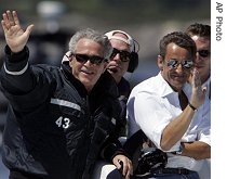 President Bush, left, and French President Nicolas Sarkozy, wave while on a boat ride off Kennebunkport, Maine