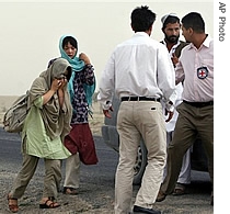 Two released South Korean hostages, left and 2nd left, are seen walking toward a International Committee of The Red Cross' (ICRC) vehicle in Ghazni province, west of Kabul, Afghanistan, 13 Aug 2007