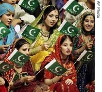 Pakistani girls wave national flags at a flag hoisting ceremony in Islamabad, 14 Aug 2007