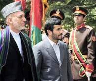 Visiting Iranian President Mahmoud Ahmadinejad, center, and Afghan President Hamid Karzai, left, inspect a guard of honor prior to their meeting at the Presidential palace in Kabul, Tuesday, Aug. 14, 2007