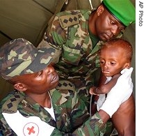 Doctor's from the Ugandan peacekeeping force in Somalia examine a malnourished boy at their field hospital at the Halane Camp just south of Mogadishu, 20 Jul 2007