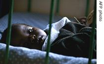 A Young HIV positive orphan lies in his cot at the Nyumbani children home, a hospice for AIDS orphans in Nairobi, Kenya 