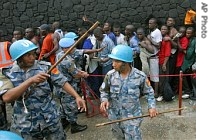 Nepalese UN peacekeepers try to contain Liberian men, some of whom have lined up for two days to register for the new Liberian Army in Monrovia, Liberia, 19 Jan. 2006