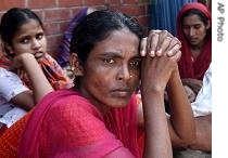 Relatives of patients look on as they sit outside a diarrhea hospital in Dhaka, Bangladesh, 19 Aug 2007