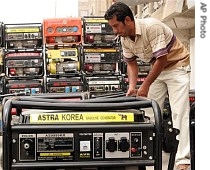 Generator salesman Ahmed Muhammad, 22, tidies up his merchandise in central Baghdad, Iraq, 4 Aug. 2007