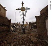 A cross remains standing in the middle of a partially destroyed cemetery in Pisco, 240 km south of Lima, Peru, 22 Aug. 2007