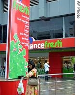 Woman walks outside a Reliance Fresh supermarket in Hyderabad, India