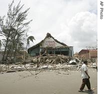 Man walks past debris at the beach of Tecolutla after the passing of Hurricane Dean in Veracruz, southern Mexico, 23 Aug 2007