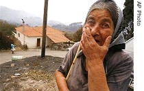 Lifelong resident of Artemida village, about 330 kilometers southwest of Athens, reacts to damage caused by fire, 27 Aug 2007