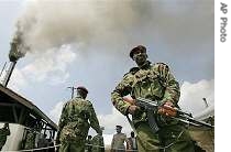 Kenyan police officer stands guard as 1.1 tonnes of cocaine goes up in smoke at an incinerator in Nairobi <br>(File Photo - 31 Mar 2006)