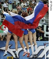 Russia's gold medal winner Tatyana Lebedeva, center, is flanked by silver medal winner Lyudmila Kolchanova and bronze medal winner Tatyana Kotova at the World Athletics Championships in Osaka, Japan, 28 Aug. 2007