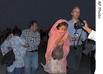 Released Korean hostages seen accompanied by foreign staff of International Committee of the Red Cross after they were released by the Taleban in Ghazni province, west of Kabul, 30 Aug 2007