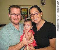 Jeff and Cerise Roth-Vinson hold Oriana, the 6-month-old girl they recently adopted in Vietnam<br /><br />