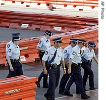 Police navigate through a maze of water filled barriers surrounding the entrance of the Convention Center at Darling Harbor, as preparations continue for next week's APEC summit, 31 Aug 2007
