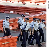 Police navigate through a maze of water filled barriers surrounding the entrance of the Convention Center at Darling Harbor, as preparations continue for next week's APEC summit, 31 Aug 2007