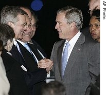 President Bush, third from right, is greeted by U.S. Ambassador to Australia Robert McCalluf and others upon his arrival at the Sydney airport, 04 Sep 2007