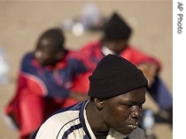 Three would-be immigrants sit on the Tejita beach in Granadilla on the Canary island of Tenerife, Spain, Tuesday, 13 Feb 2007