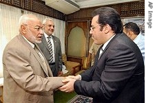 Ayman Nour, head of Al-Ghad Party and a presidential candidate, right, shakes hands with Mohammed Mahdi Akef, leader of the Muslim Brotherhood, Egypt's largest and oldest Islamic group, Cairo Aug.14, 2005