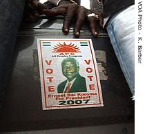 APC followers put stickers on their car to show their support with for candidate Ernest Koroma